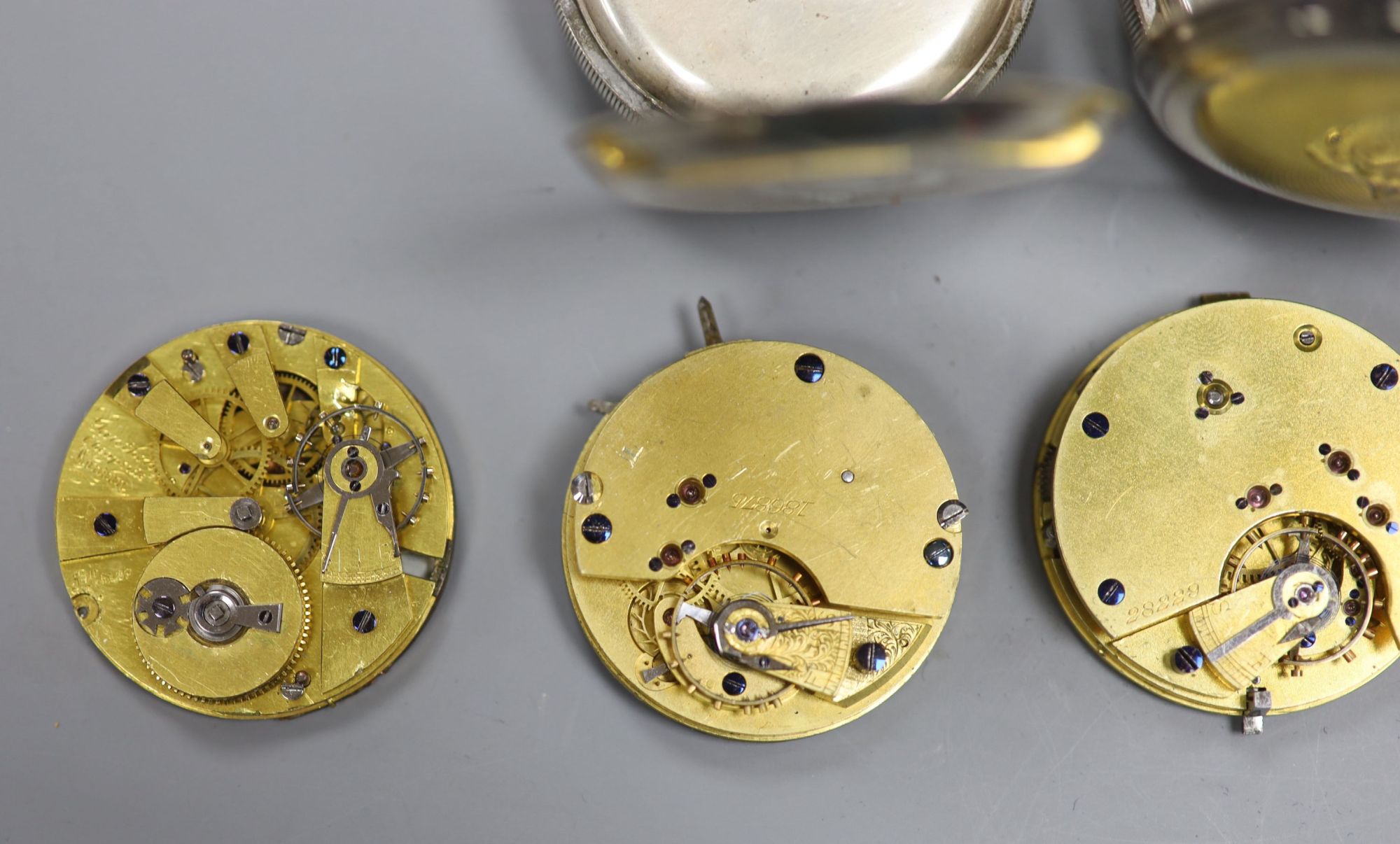 Two early 20th century silver or white metal pocket watches and four assorted pocket watch movements.